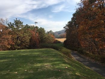 Scenic view of golf course against sky