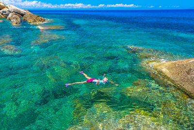 High angle view of woman swimming in sea