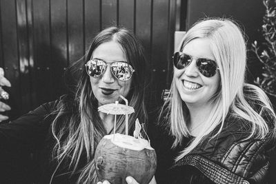 Portrait of smiling young woman wearing sunglasses