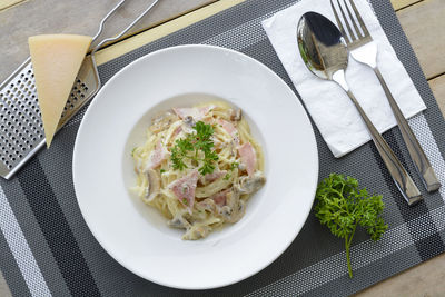 Directly above shot of spaghetti with cheese and meat in plate