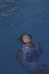 High angle portrait of woman swimming in sea