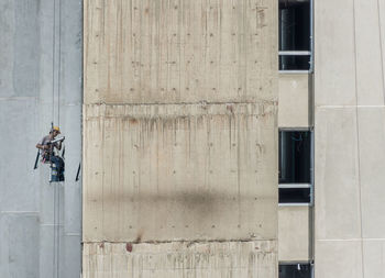 People on wall of building