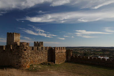 Old ruins in city against sky