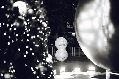 Close-up of illuminated lighting equipment hanging at night