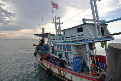 Boat moored on sea against sky