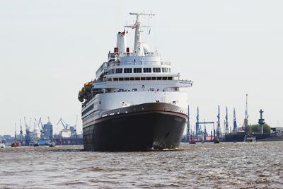 Commercial dock by sea against clear sky