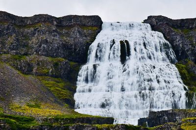 Scenic view of waterfall against sky