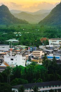 Townscape and mountains against sky during sunset