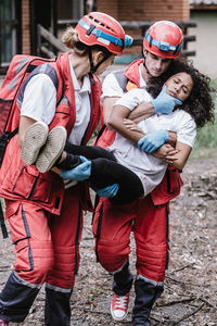 Paramedic workers rescuing woman during disaster