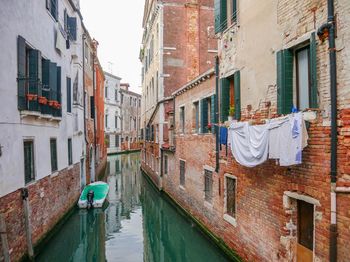 Canal amidst buildings in city