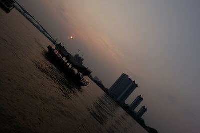 Low angle view of built structure against sky at sunset