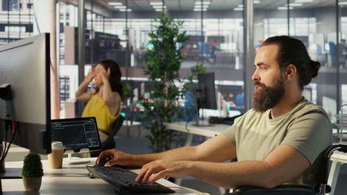 Young man using laptop at office