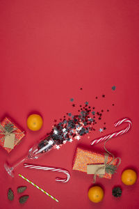 High angle view of multi colored candies against red background