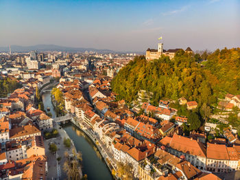 High angle view of river amidst buildings against sky