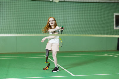 Girl with artificial leg playing badminton