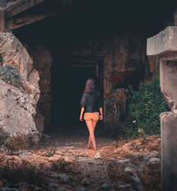 Full length of woman standing against building