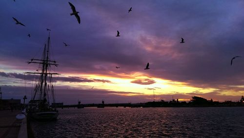 Scenic view of sea against cloudy sky at sunset