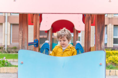 Portrait of cute boy against built structure