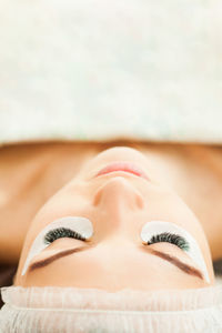 Midsection of woman lying on carpet