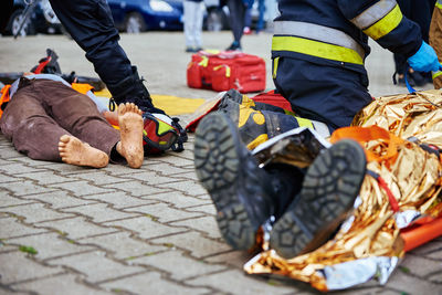 Rescuers provide first aid to the victim during car road accident