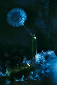 Close-up of water falling on glass bottle