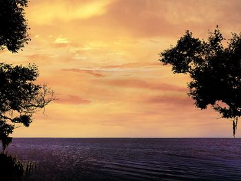 Scenic view of sea against sky at sunset