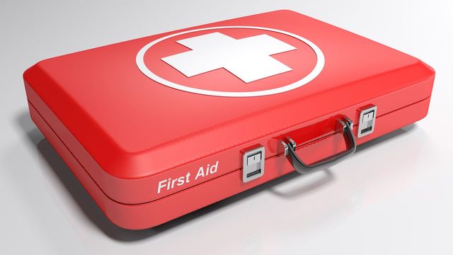 Close-up of first aid kit on gray background | ID: 119558896