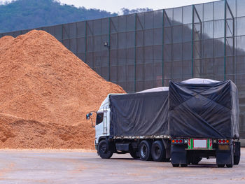 Truck on road by building