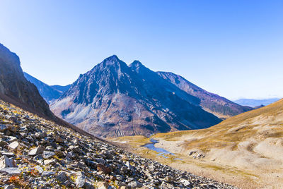 Scenic view of mountains against clear blue sky