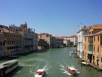 Boats in canal with buildings in background