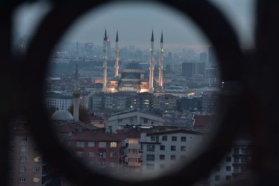 Cityscape against sky seen through window