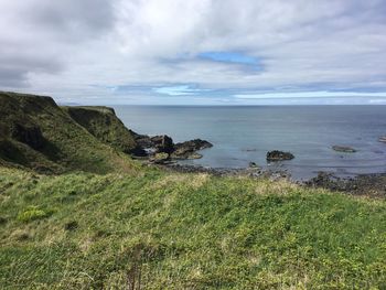 Scenic view of sea against cloudy sky