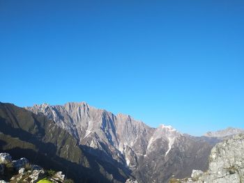 Scenic view of mountains against clear blue sky