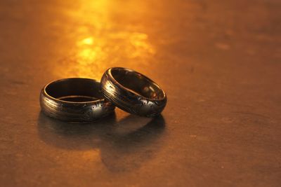 Close-up of wedding rings on table