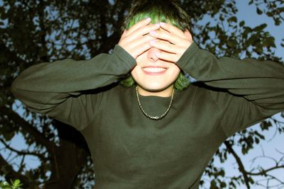 Portrait of senior man against tree