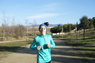 Smiling woman running outdoors