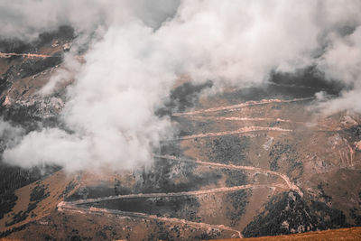 Aerial view of smoke on land against sky