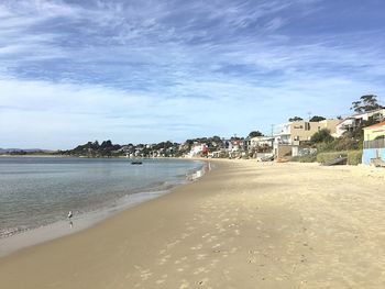 View of beach against cloudy sky