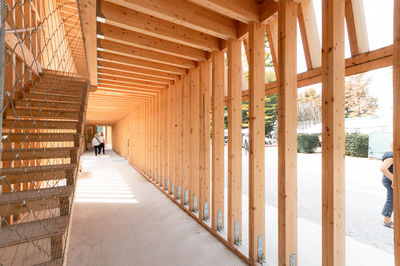 Rear view of man standing in building wood crafted during an exibition.