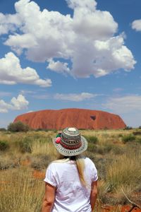 Rear view of woman on field against sky