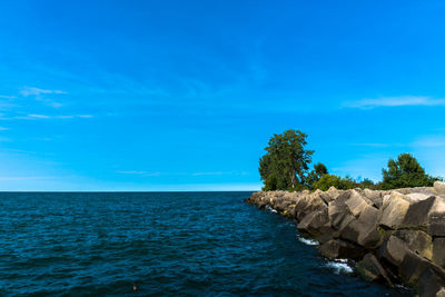 Scenic view of sea against blue sky