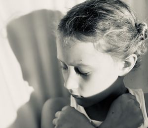 Close-up portrait of girl against wall