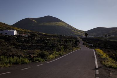 Road amidst landscape against clear sky