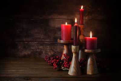 Close-up of illuminated candles on table