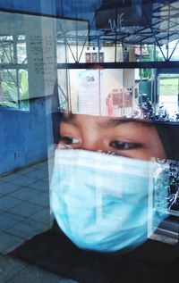 Portrait of man looking through window