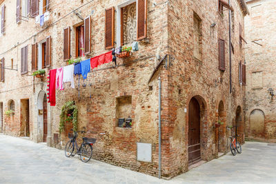 Idyllic italian alley with hanging laundry and a parked bicycles