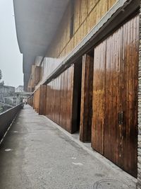 Empty road amidst buildings against clear sky