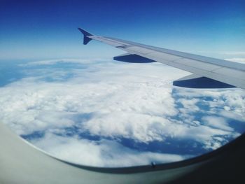 Cropped image of airplane wing over landscape