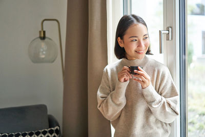 Portrait of young businesswoman working at home