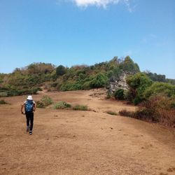 Full length of woman standing on landscape